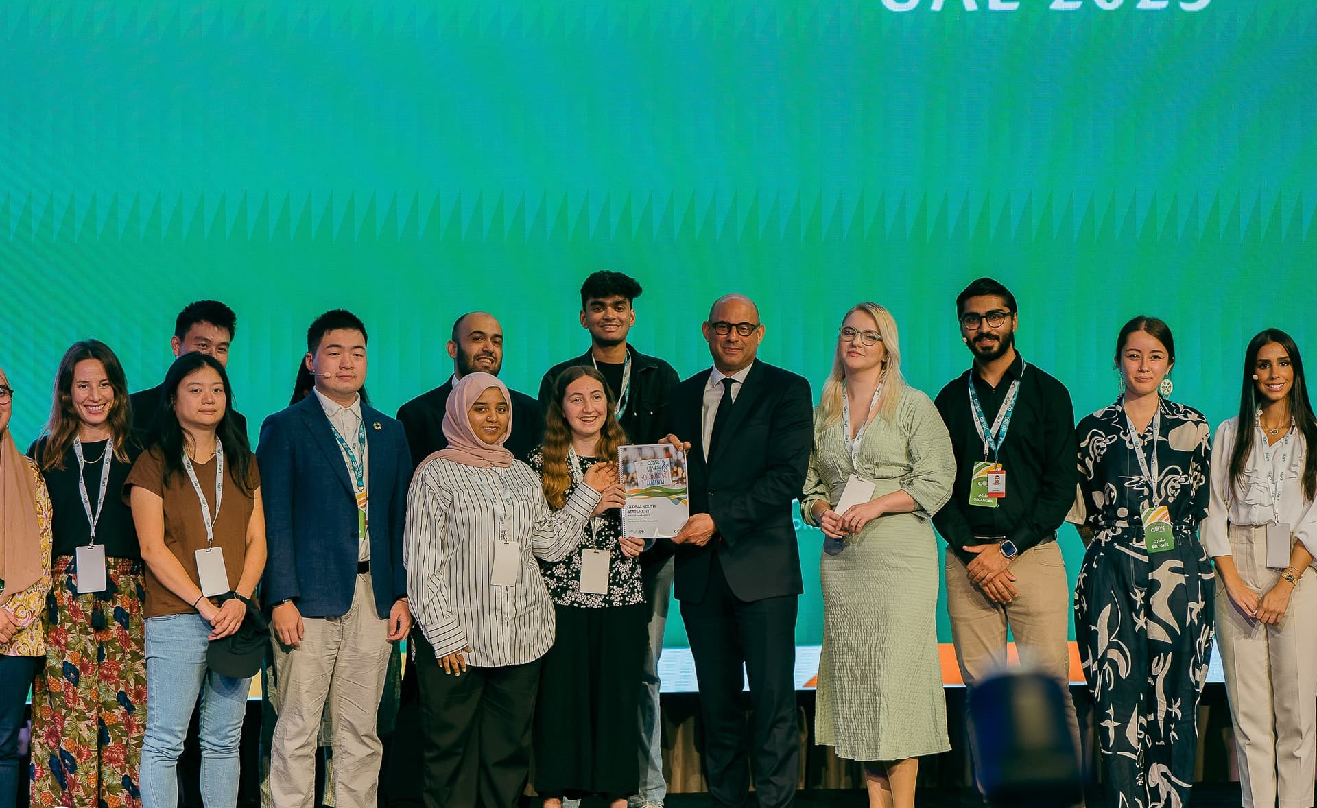 COY18 youth delegates presenting the Global Youth Statement with a UNFCCC official in the UAE