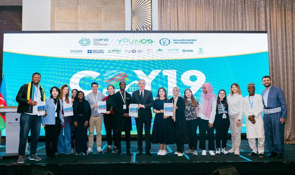 COY19 delegates with the Global Youth Statement on stage in Baku