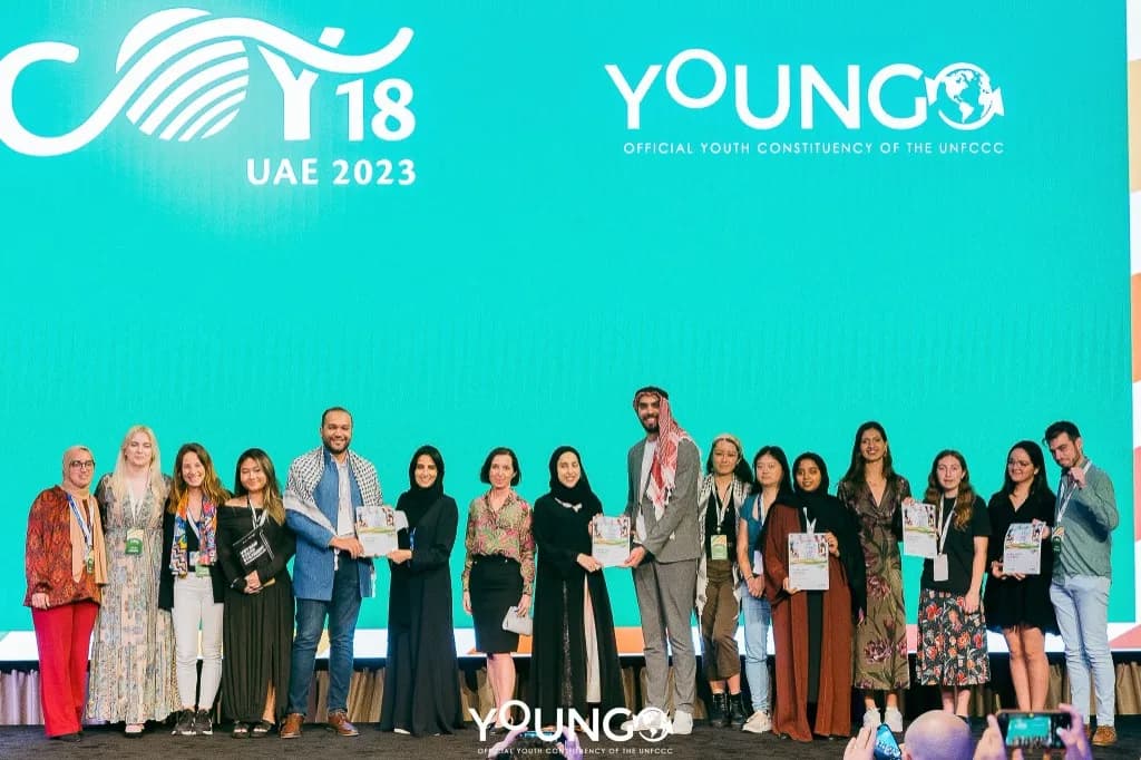 COY18 delegates presenting the Global Youth Statement on stage in the UAE